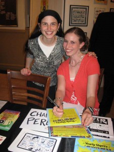 Chari Pere signs a copy of \